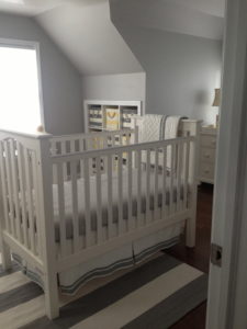 Baby nursery with baby bed in the center of the room.