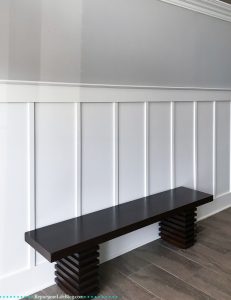 Image of a bench in front of a wall of board and batten, used with permission from Repurpose Life Blog.