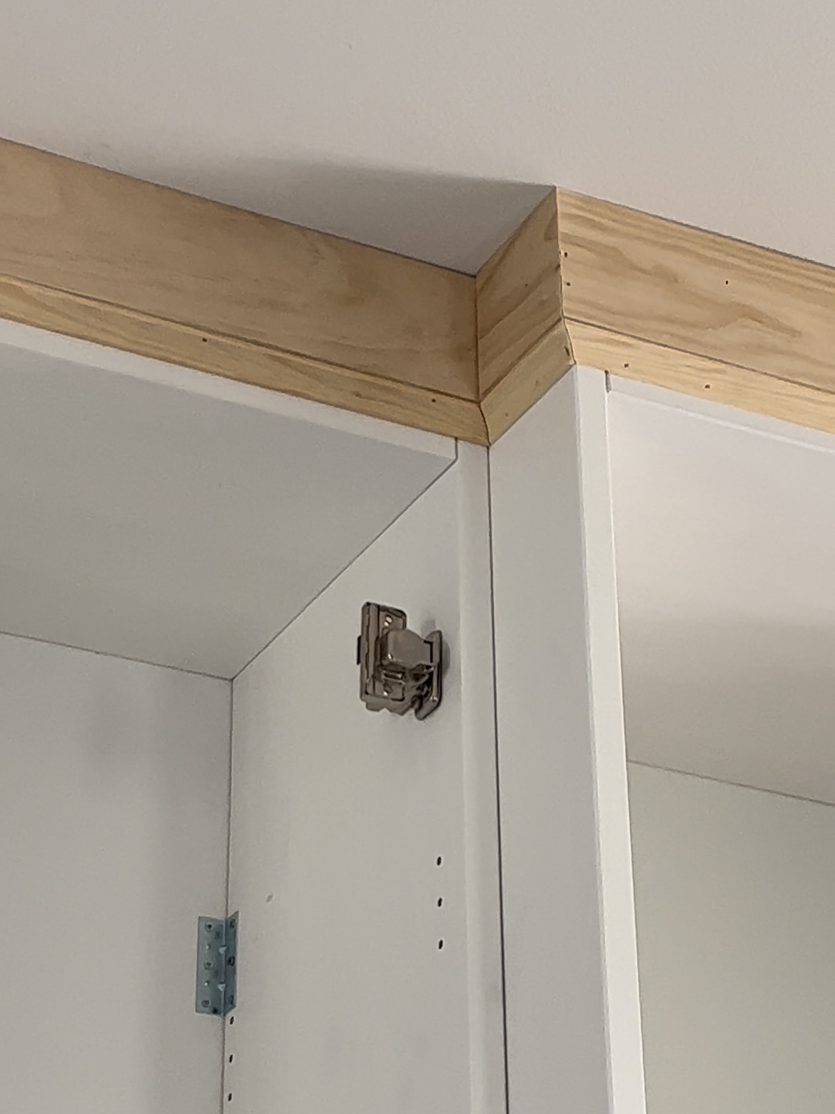 Crown moulding attached to cabinets and ceiling.