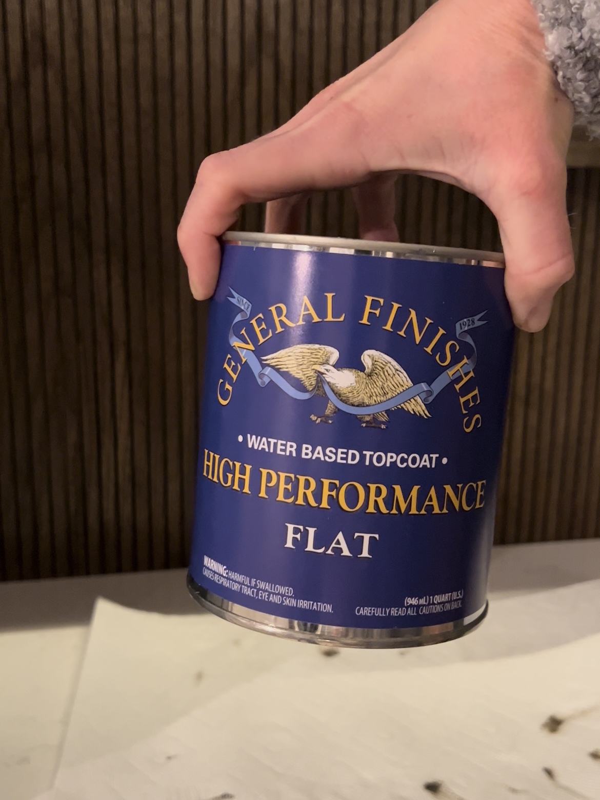Hand holding can of General Finishes topcoat.