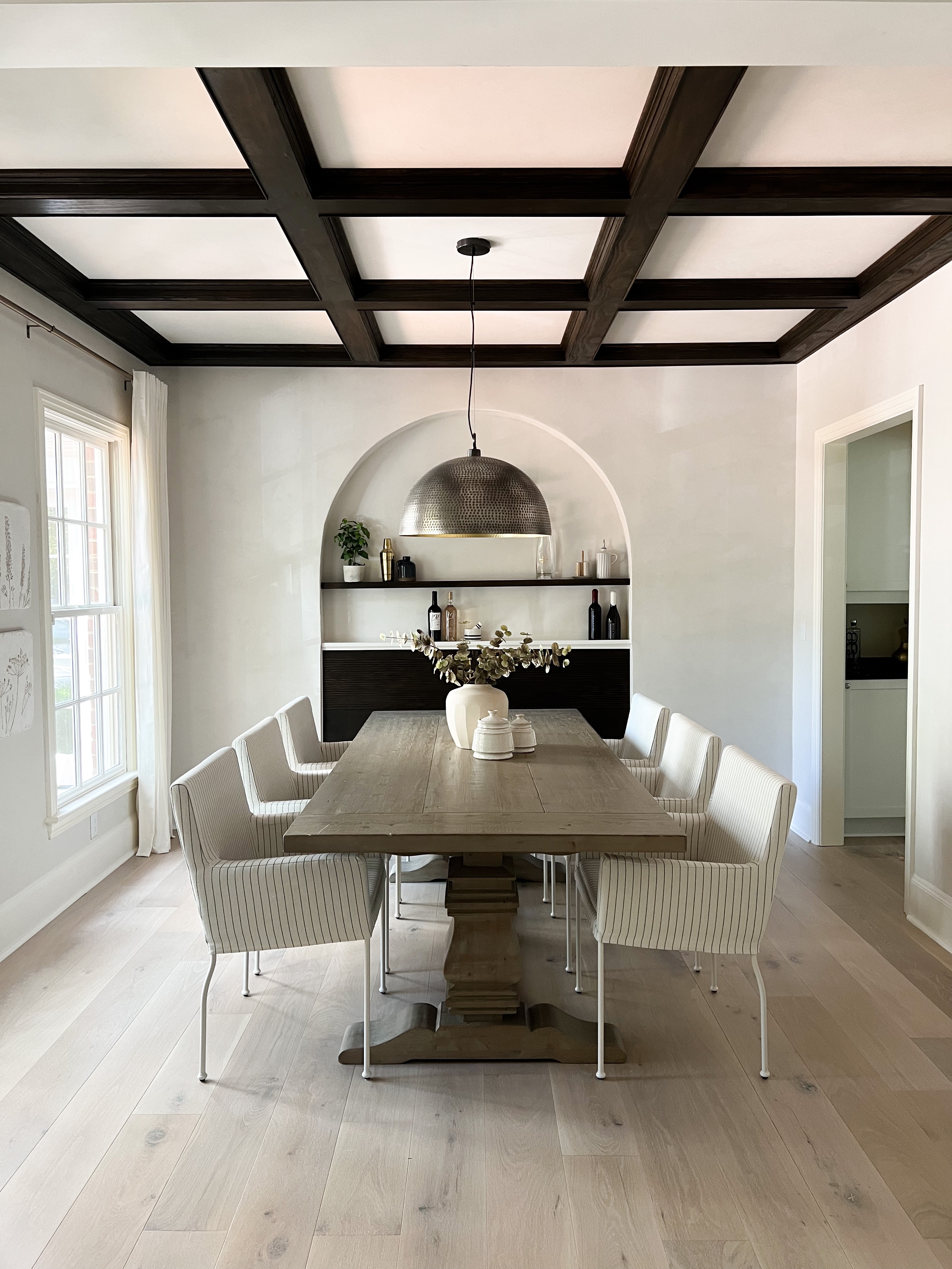 Image of a dining room with a deep wood diy coffered ceiling.