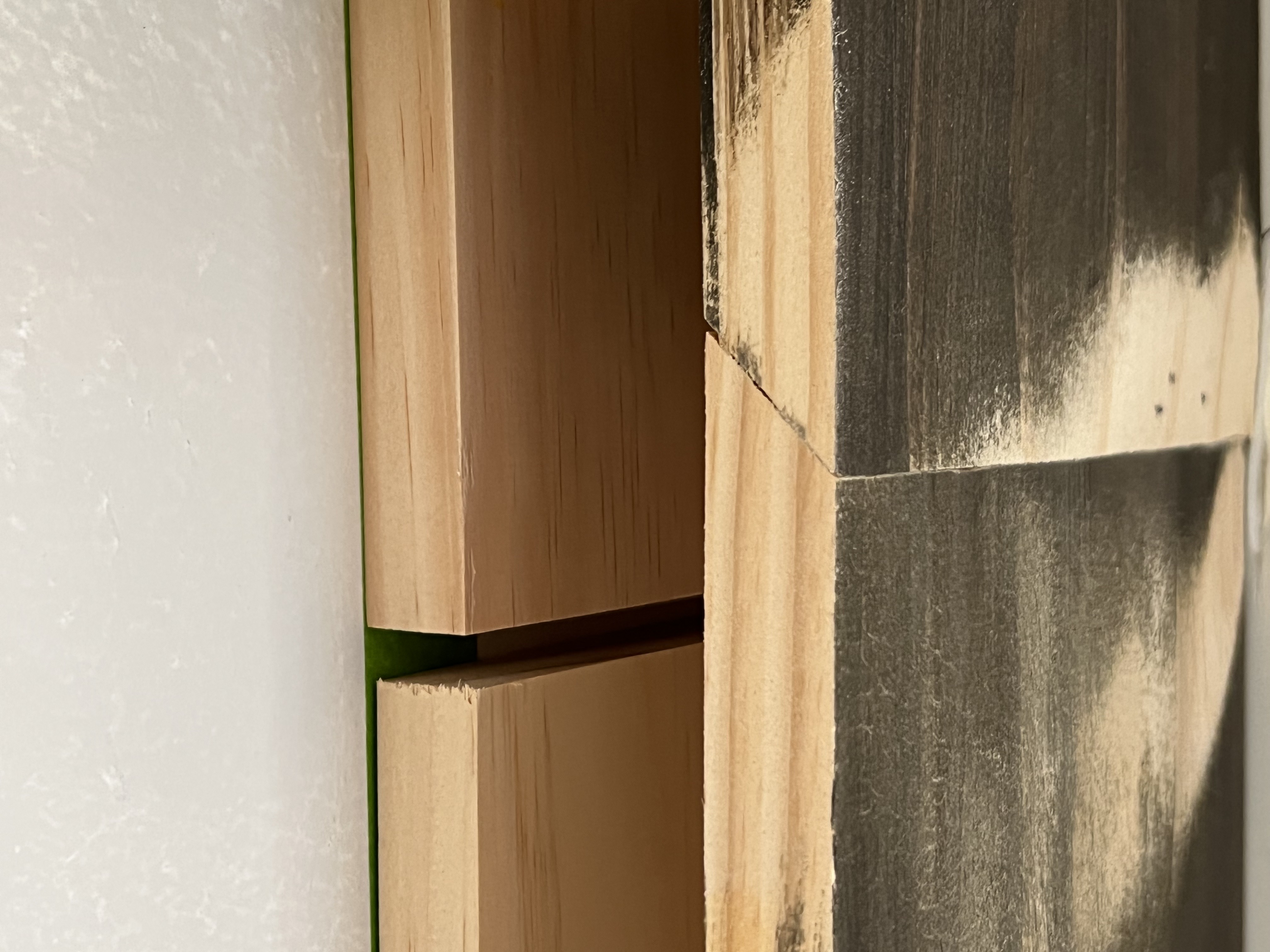 Image of a 45 degree beveled seam joining two pieces of wood together.
