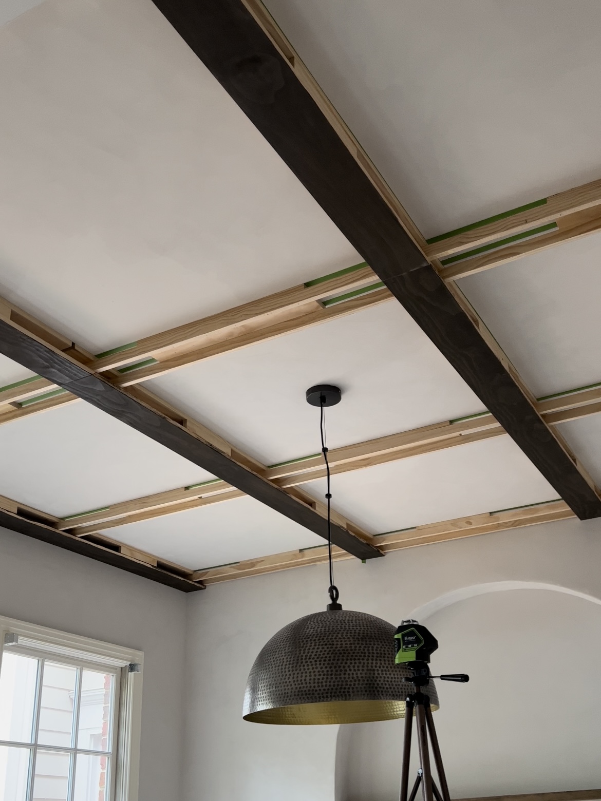 Process photos of installing a coffered ceiling.