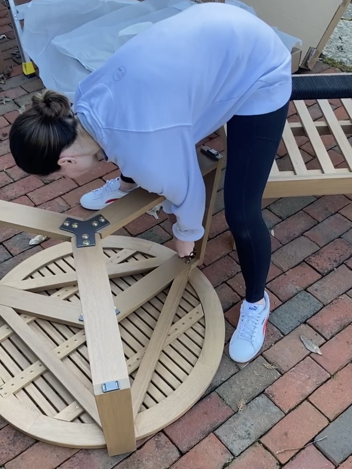 Woman putting together a table.