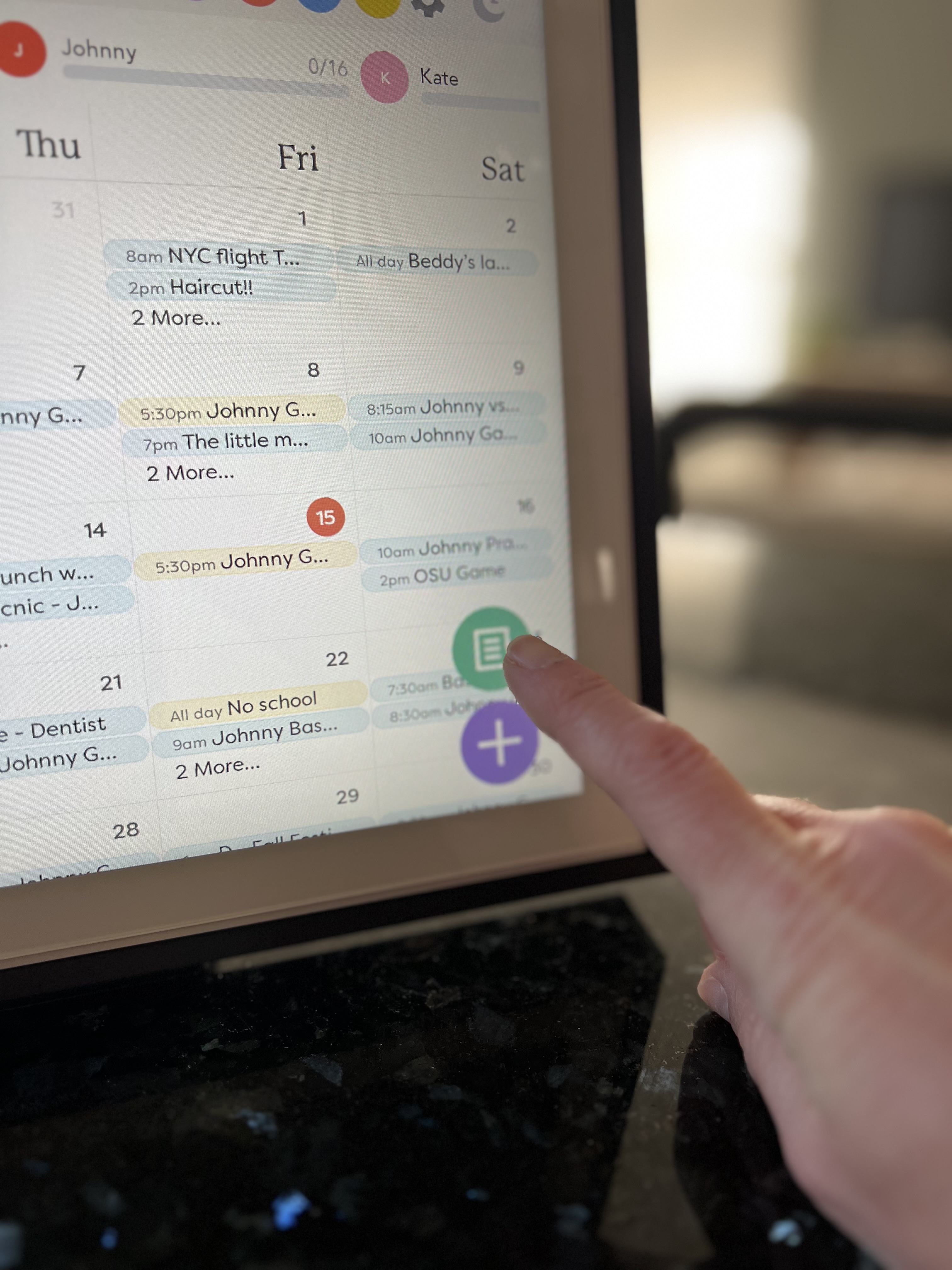 Tapping the family calendar touch screen to add an activity.