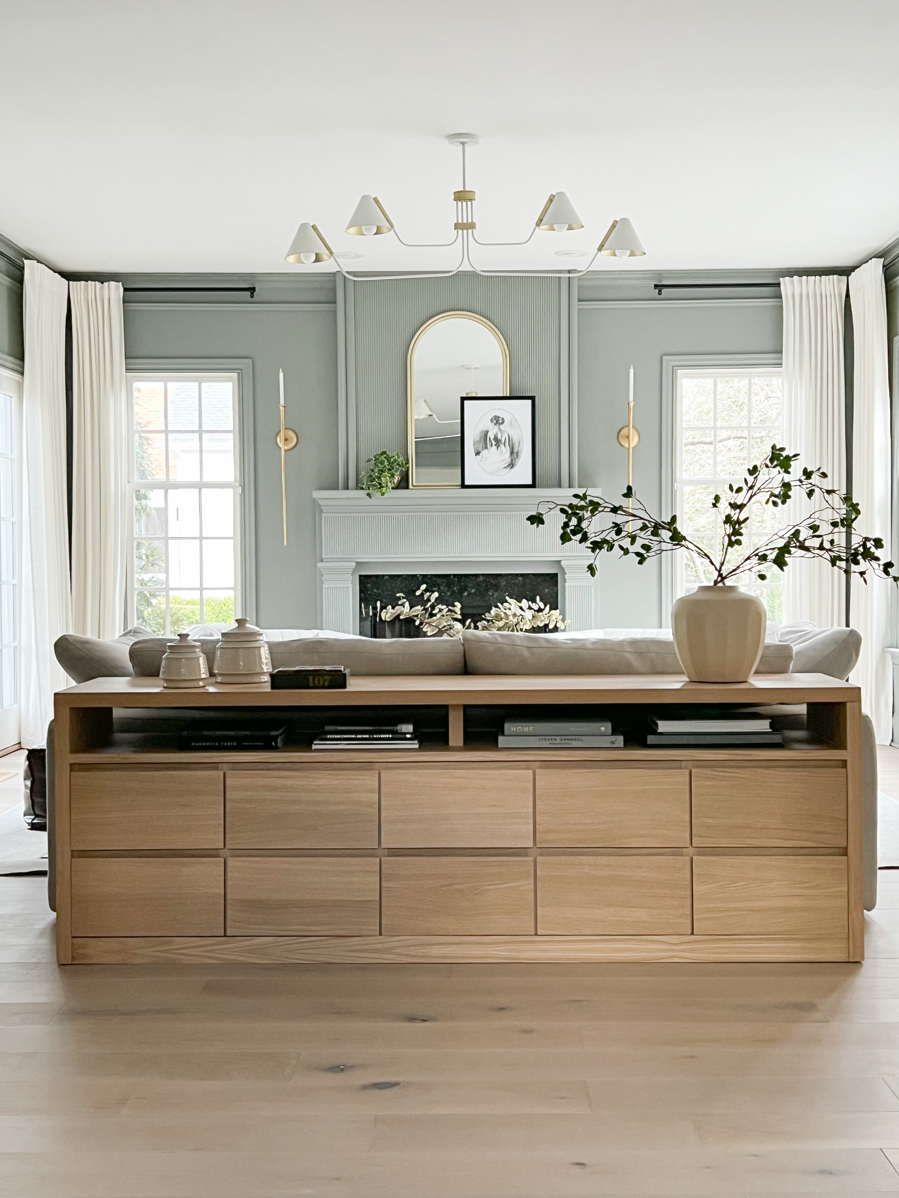 Long white oak sofa table with 10 drawers, and storage on top.