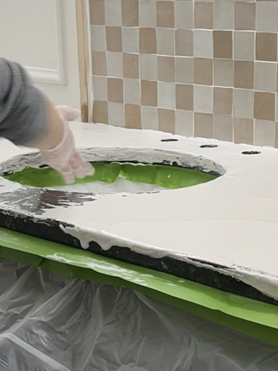 Wet faux cement oozing down the side of a countertop.