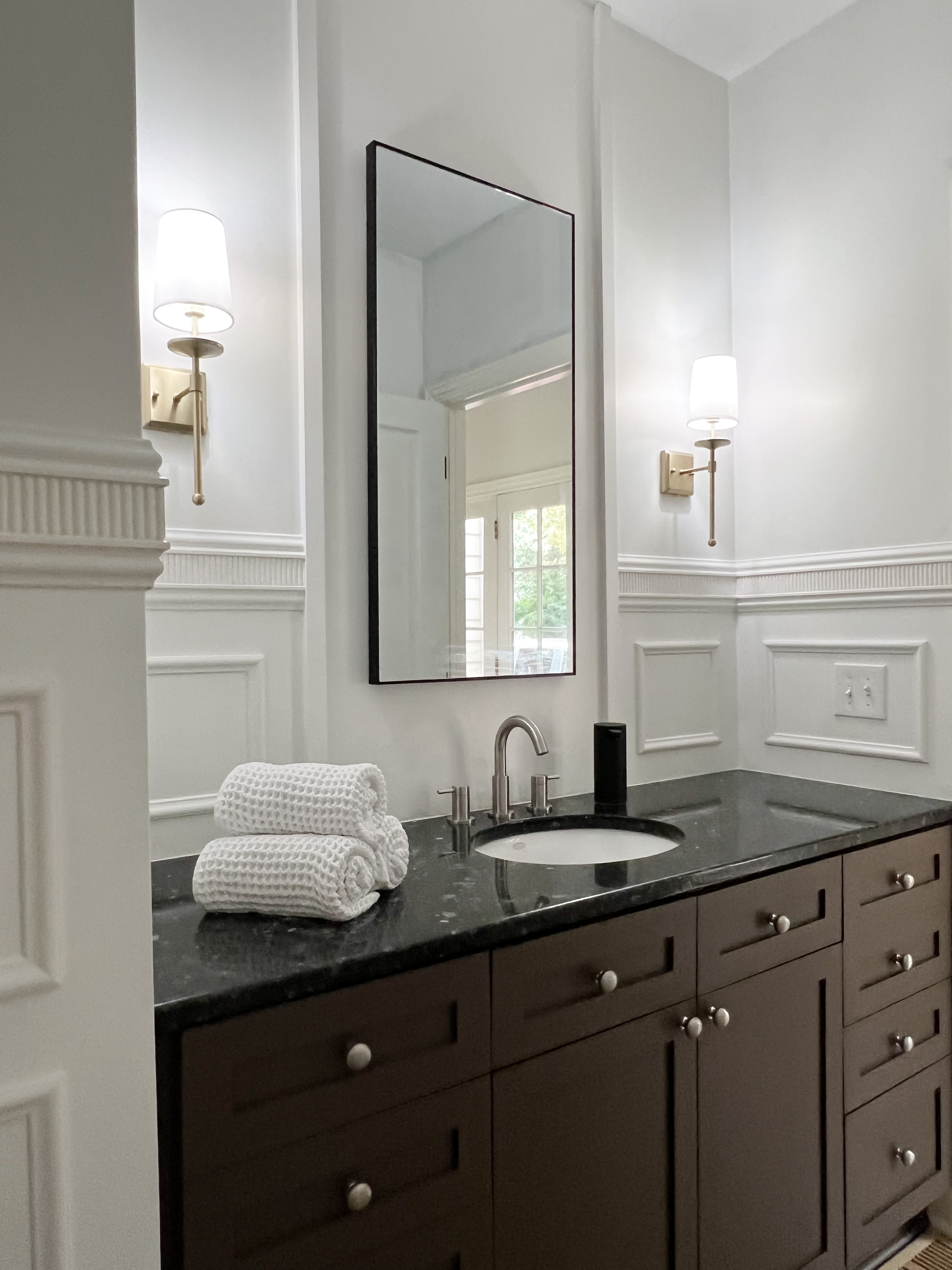 Powder Bathroom Makeover with new wall trim and light sconces.