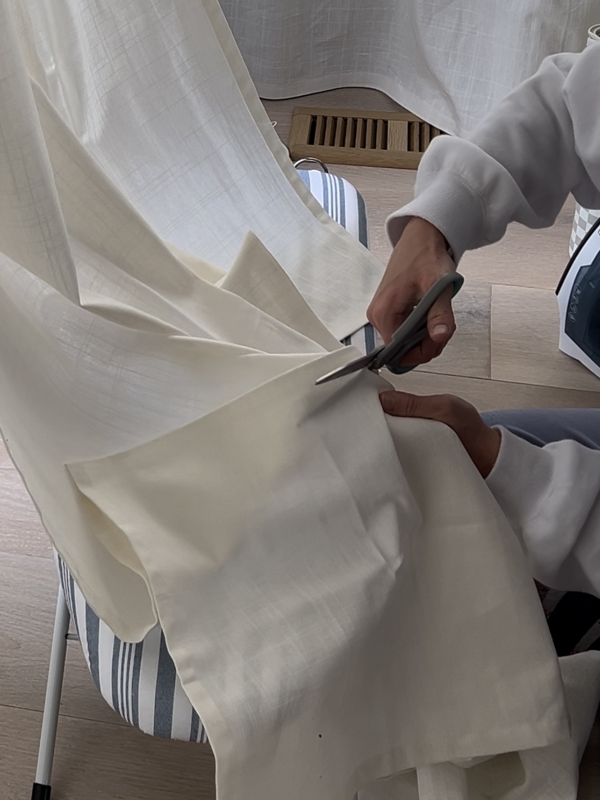 Cutting statement curtains before hemming them.