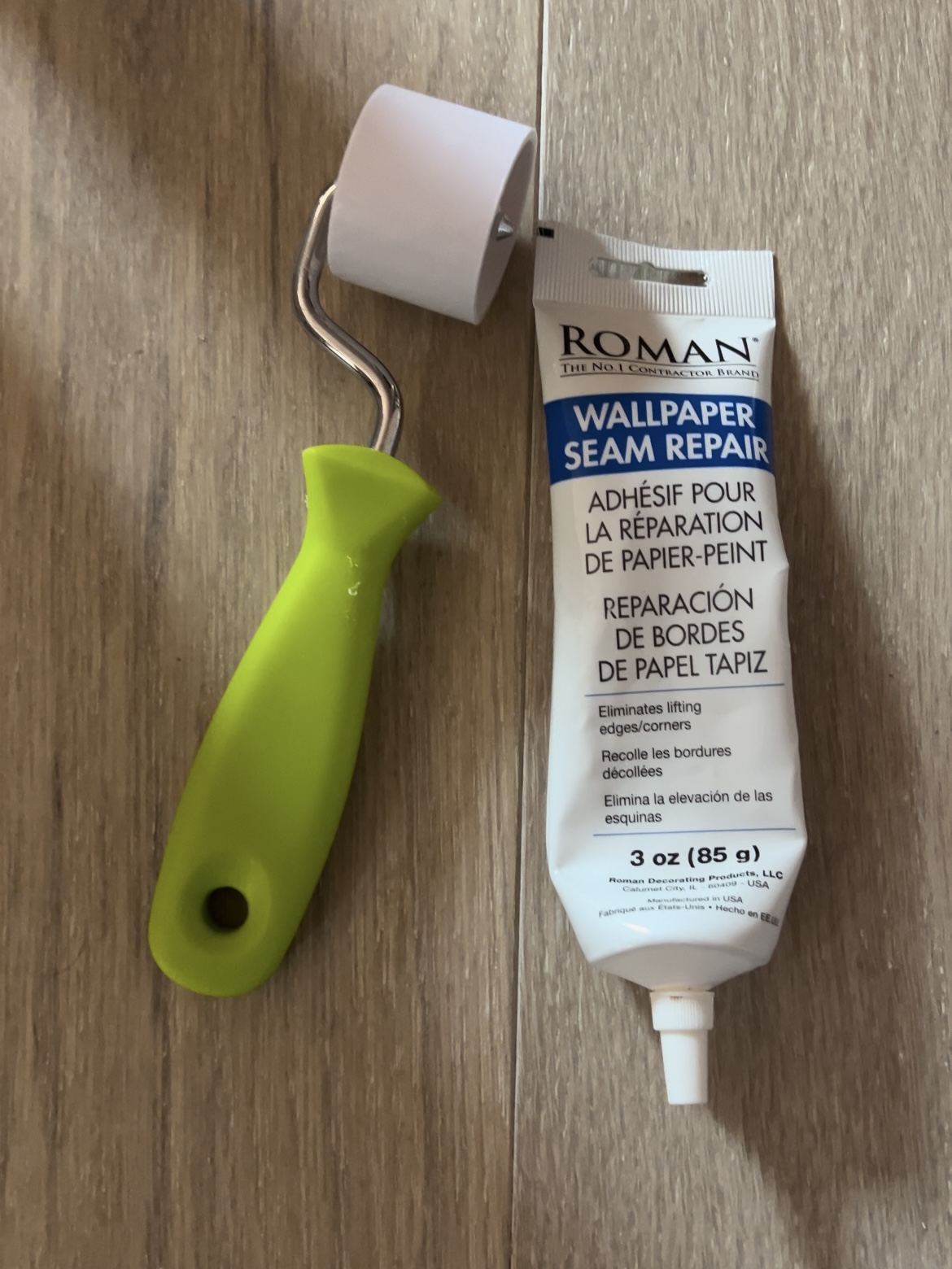 Tools for wallpaper installation: Wallpaper seam repair adhesive and wallpaper seam roller.